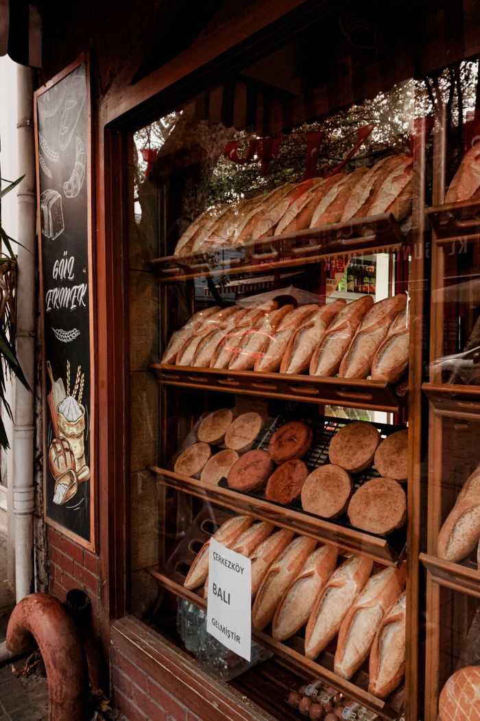 Artisan breads displayed in a charming bakery storefront.